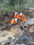 Crew Manhandling debris from a pipe