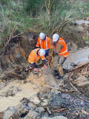 Crew Manhandling debris from a pipe